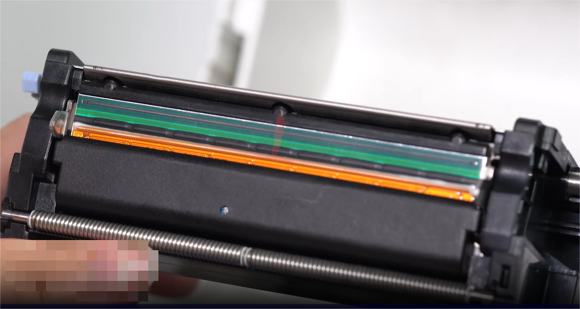 A:n close-up of a person carefully cleaning an electronic component with a swab.